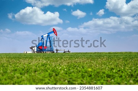 Pump jack on field oil industry landscape