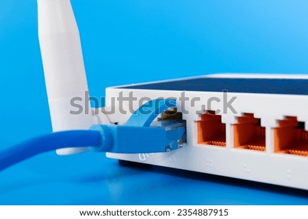 Internet router, wi fi, online communication in a computer network, blue background Royalty-Free Stock Photo #2354887915