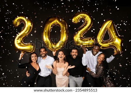 Happy multiracial men and women three loving millennial couples wearing nice outfits celebrating new year 2024 together on black background, holding golden number baloons and smiling at camera Royalty-Free Stock Photo #2354895513