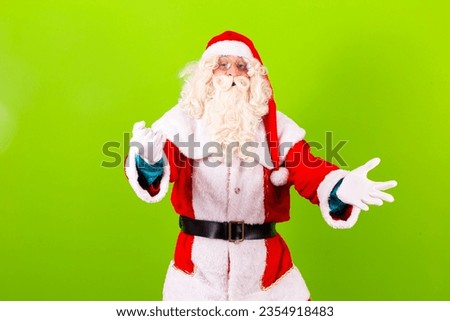 Santa Claus pointing to the side with space for text. Santa Claus on green background pointing to the free space for text.