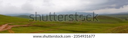 Panoramic view of a dirt road in the Orkhon valley in Mongolia.