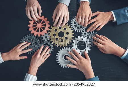 People joining cog wheel on the black desk. Royalty-Free Stock Photo #2354952327