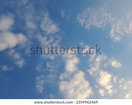 Beautiful white clouds on deep blue sky background. Large bright soft fluffy clouds are cover the entire blue sky. Skyscape on Lombok Island, Indonesia