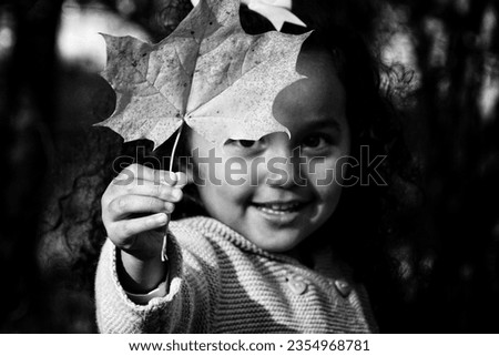 Portrait of a girl holding a leaf 