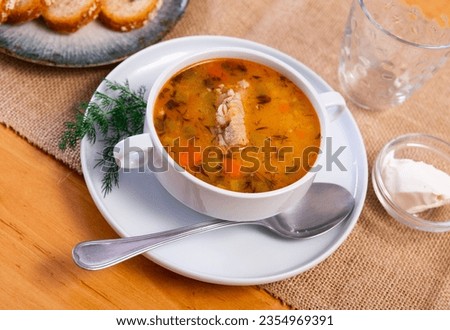 Traditional Russian thick sour soup rassolnik served with a piece of boiled beef Royalty-Free Stock Photo #2354969391