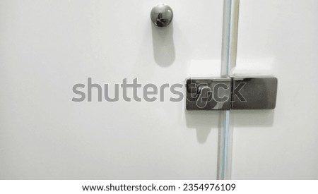 modern metal door lock in public bathroom. copy space.