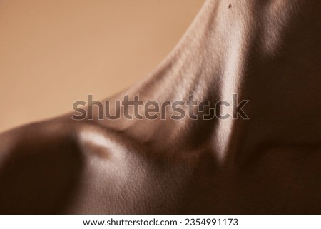 Skincare, textures and closeup with neck of person in studio for health, beauty and cosmetics. Wellness, body and aesthetic with zoom of woman on brown background for glow dermatology and glamour Royalty-Free Stock Photo #2354991173