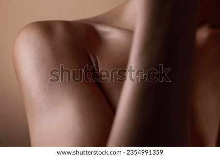 Healthy, skin and body closeup on woman, shoulder or natural glow and skincare texture in studio with cosmetics. Beauty, self care and arm of female model with clean, hygiene and aesthetic wellness Royalty-Free Stock Photo #2354991359
