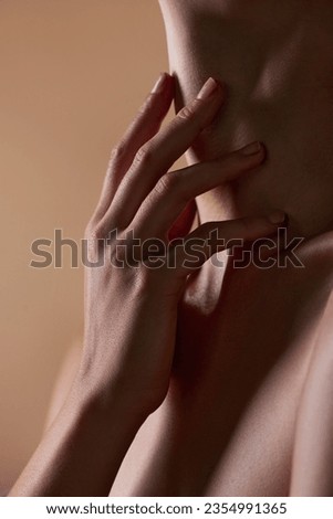 Skincare, touch and closeup with neck of person in studio for health, textures and cosmetics. Wellness, body and aesthetic with zoom of woman on brown background for glow dermatology and glamour Royalty-Free Stock Photo #2354991365
