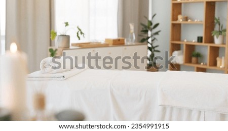 Wellness, relax and a massage table on an empty spa background for luxury wellness or treatment. Health, zen and hospitality with candles for peace or aromatherapy a room of a modern beauty salon