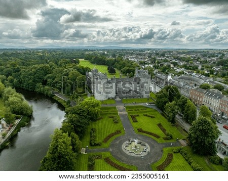 Aerial view of Kilkenny castle, Victorian remodeling of a medieval defensive structure, rolling parkland, terraced rose garden, woodlands, man-made lake by the Nore river Royalty-Free Stock Photo #2355005161