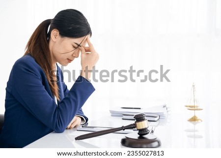 A lawyer or businessman is stressed about losing a lawsuit and going bankrupt. Royalty-Free Stock Photo #2355027813
