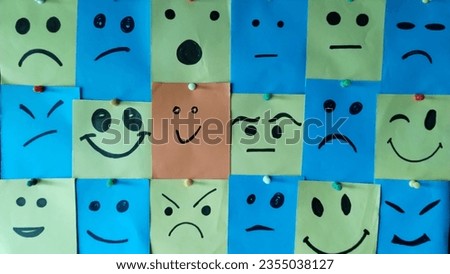 A group of paper notes with smiley faces.