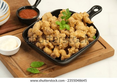 Homemade Crispy Popcorn Chicken with Sauce on white background