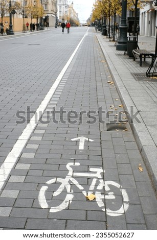 Bicycle route sign on the city road and arrow pointing direction