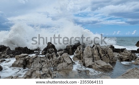 Sea surf that expands in the air during. Sea driven by the fresh Mistral wind. Freedom of nature. Ancient rocks that on the coast embrace the impetuous sea that breaks furiously Royalty-Free Stock Photo #2355064111