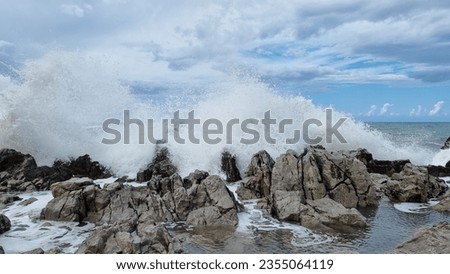 Sea surf that expands in the air during. Sea driven by the fresh Mistral wind. Freedom of nature. Ancient rocks that on the coast embrace the impetuous sea that breaks furiously Royalty-Free Stock Photo #2355064119