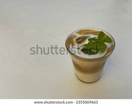 I took this picture myself. I put the latte in a transparent cup and put the herb on it.