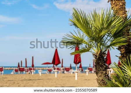 Parasol umbrella on tropical island beach. Colourful sunshade in the beach on sunny summer day. Holiday relaxation with turquoise sea and blue sky landscape. Summer vacation travel concept