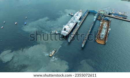 Tug boat pull cargo container ship from dry dock concept maintenance service working in the sea. Insurance and Maintenance Cargo Ship concept. Freight Forwarding Service maintenance Insurance