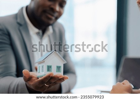 Real Estate Agent and client talking about Property insurance and security concept about house to client before sign contract