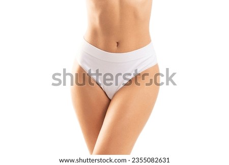 Young and beautiful slender girl in white swimsuit posing over white background. Healthcare, diet, sport and fitness concept.