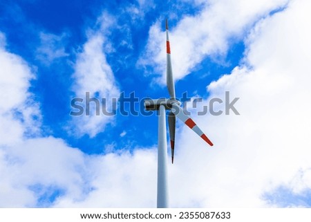 A wind farm or wind farm at sunset on the clouds located in the mountains of Italy Europe and allows to make clean energy. It is sustainable and renewable energy for the environment background