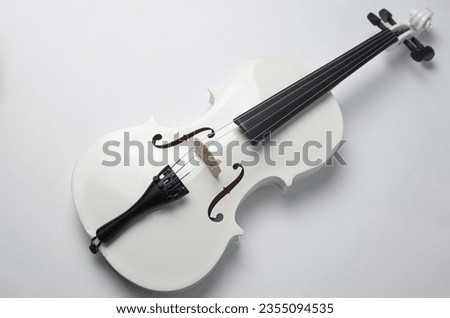 White violin on a gray background