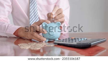 Businessman hand putting bitcoins into pink piggybank. risk and wealth can happen in investment savings or trading in cryptocurrency innovation