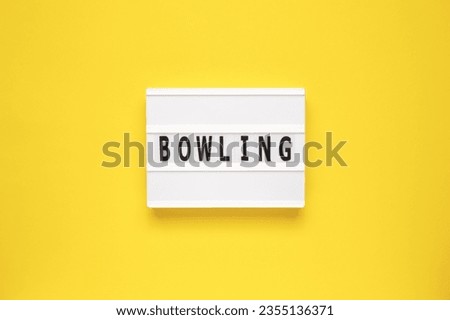 The word bowling on lightbox isolated yellow background.