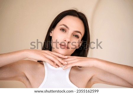 brunette woman with healthy radiant skin and natural makeup posing on camera. eyebrow lamination procedure, skincare treatment. advertising concepts of cosmetology, dermatology and aesthetic medicine Royalty-Free Stock Photo #2355162599