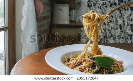 a picture of spaghetti in tomato sauce with meat on a fork, delicious spaghetti in tomato sauce with bacon, basil, and other ingredients,Italian cuisine
