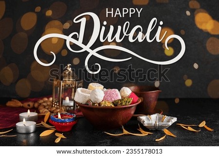 Greeting card for Happy Diwali (Festival of lights) with Indian sweets and glowing candles Royalty-Free Stock Photo #2355178013