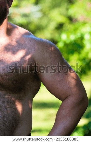 Bodybuilders' arm muscles. Close up of a male body.