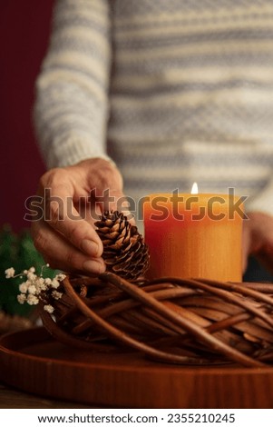 Woman lighting wreath candle fire