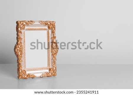 Beautiful vintage empty frame on white table, space for text