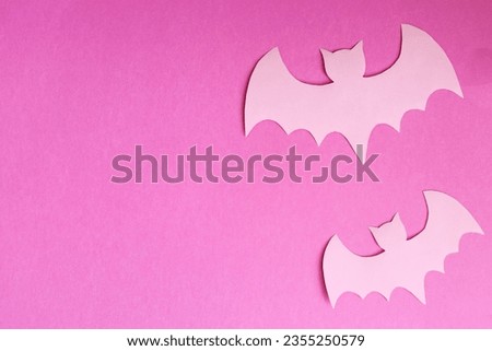 pastel pink bats on a pink paper background halloween concept