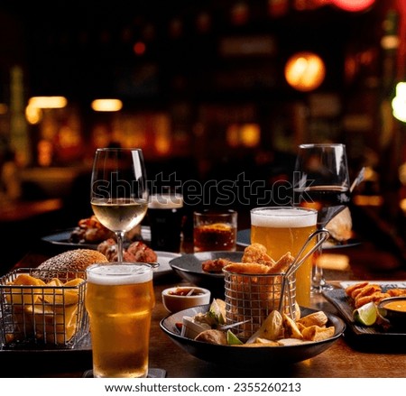 dinner banquet with prawns finger food portions on a table set with starters beers wines drinks Royalty-Free Stock Photo #2355260213