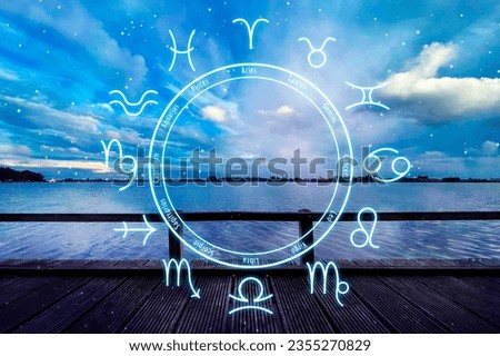 Zodiac wheel and beautiful view on wooden pier under cloudy sky