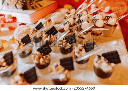 A sweet table at a wedding. Table with cakes and sweets at the festival. Birthday sweets