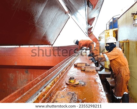 Hold cleaning operation on a cargo ship or a bulk carrier  Royalty-Free Stock Photo #2355298211
