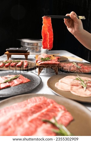 Woman hand using chopsticks pinking up wagyu beef. Grilled japanese premium wagyu beef Sirloin steak