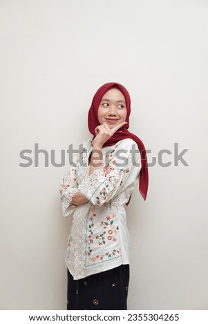 Young asian woman smiling to camera standing pose on isolated white background. Female around 25 in suit portrait shot in studio.