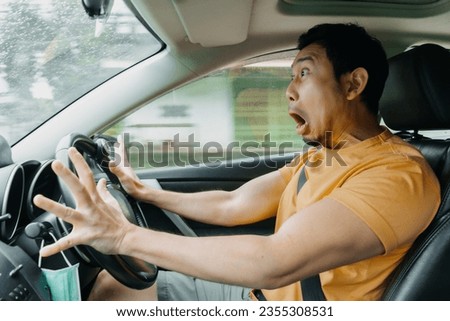 Asian man driving shocking car accident crashing.  Royalty-Free Stock Photo #2355308531