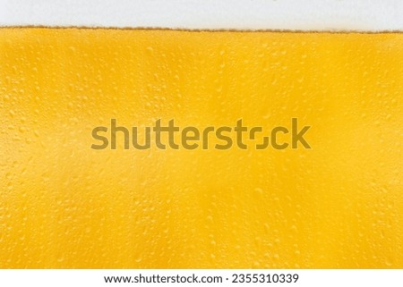 Close-up view of beer with white foam. Oktoberfest concept Royalty-Free Stock Photo #2355310339