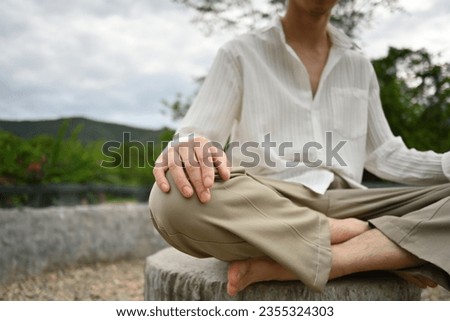 Close-up image of Young Asian man meditating.
