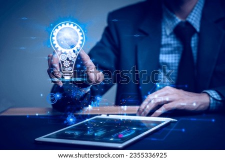 Businessman holding a light bulb with icon book success of busines, Creative new idea. Innovation, brainstorming, solution and inspiration concepts. imagination, Ai technology.