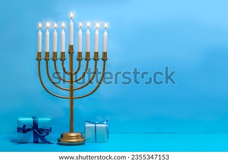 Jewish Hanukkah Menorah 9 Branch Candlestick, gift box. Holiday Candle Holder. Nine-arm candlestick. Traditional Hebrew Festival of Lights candelabra. Background for design with copy space. Royalty-Free Stock Photo #2355347153