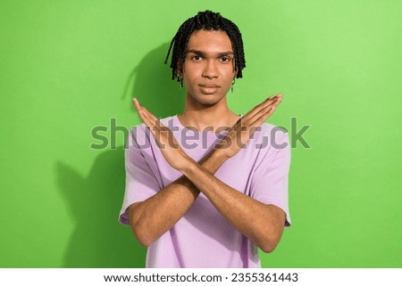 Photo of concentrated person crossed arms demonstrate stop enough symbol isolated on green color background