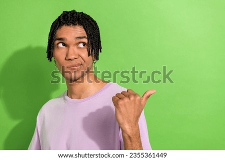 Photo of doubtful minded person look direct thumb finger empty space ad isolated on green color background